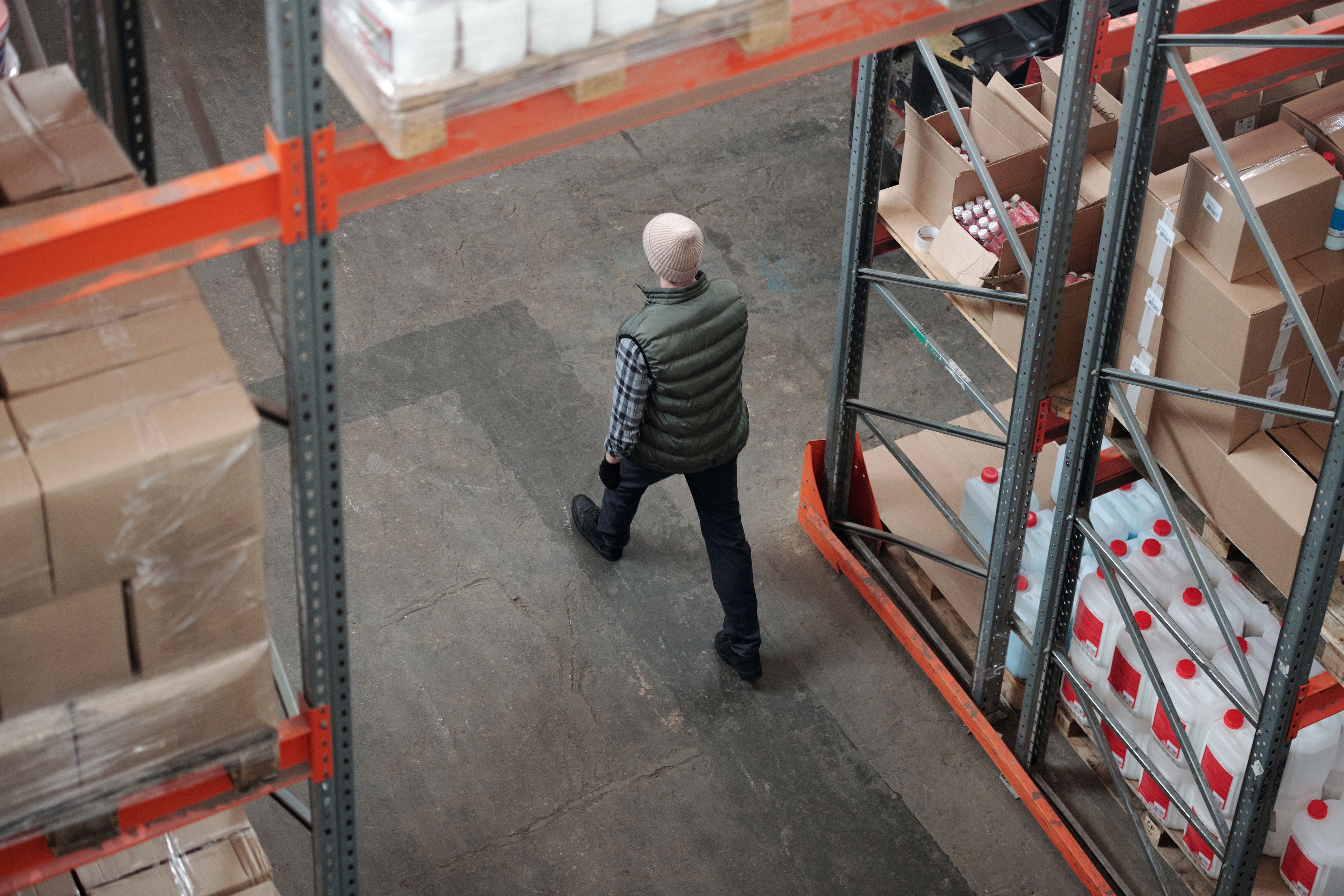 Forklift moving pallets down a warehouse aisle